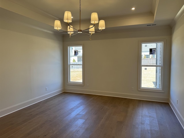 unfurnished room featuring baseboards, visible vents, a raised ceiling, dark wood-style flooring, and a chandelier