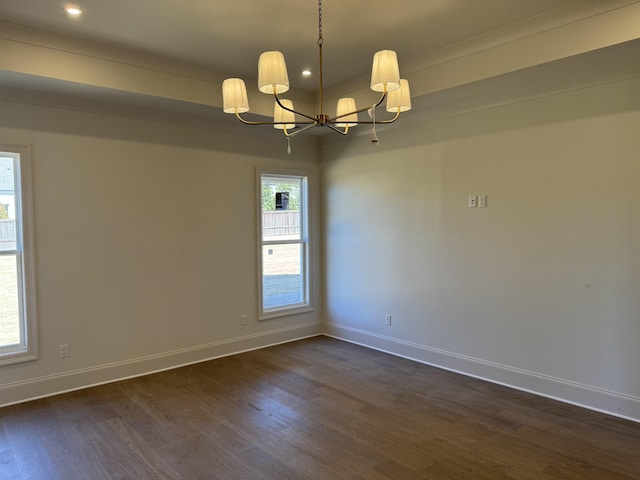 spare room with baseboards, dark wood-type flooring, recessed lighting, and an inviting chandelier