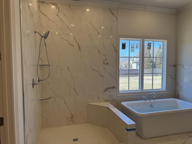 full bath with a freestanding tub and a marble finish shower