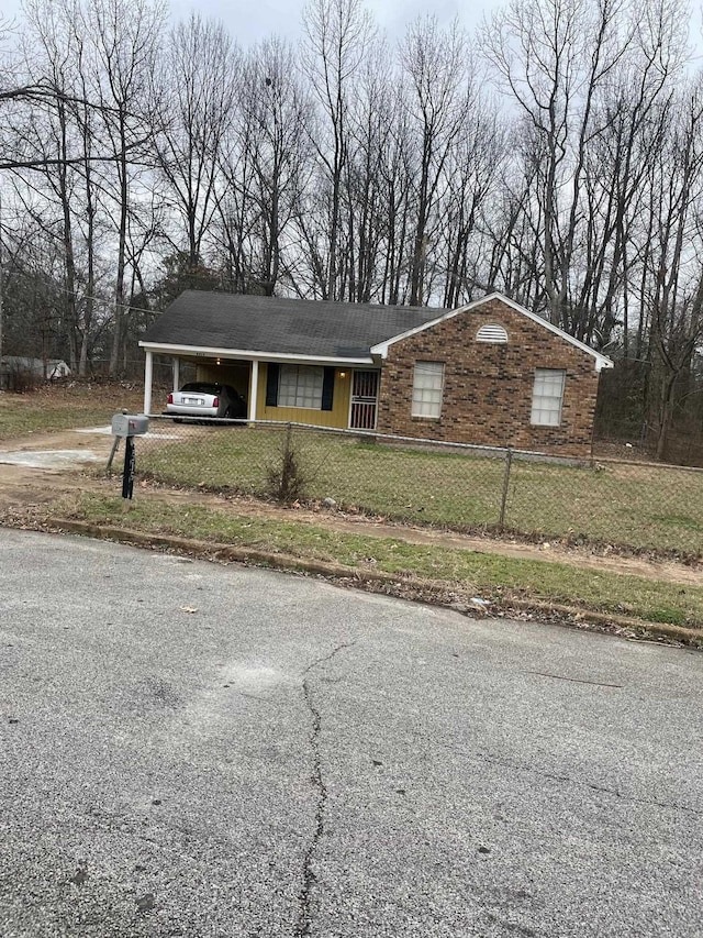 3516 Suzanne Dr, Memphis, TN 38127 - single story home featuring a fenced front yard, asphalt driveway, and a carport