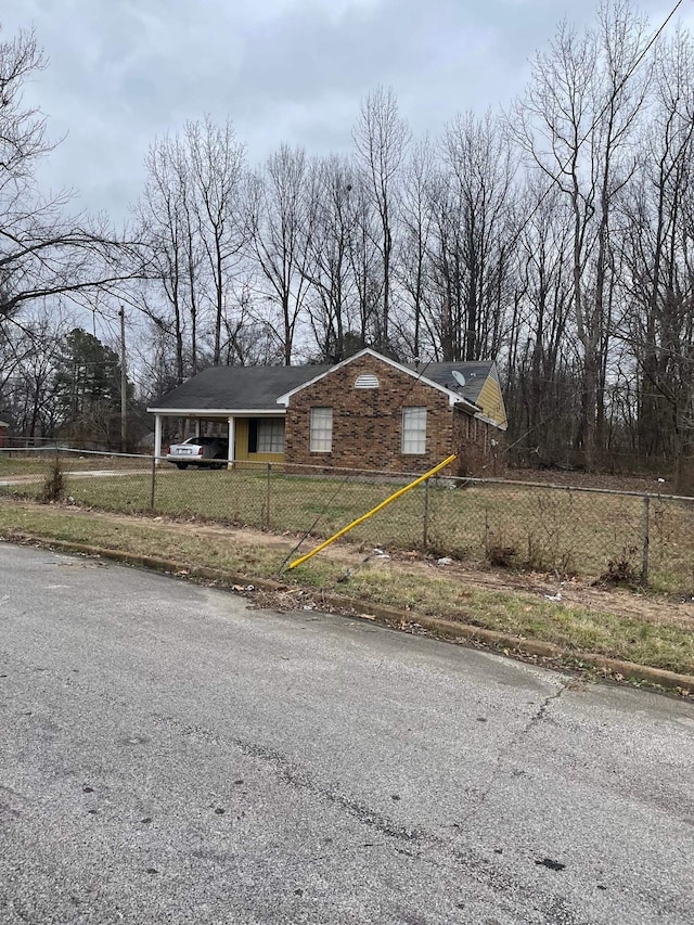 3516 Suzanne Dr, Memphis, TN 38127 - ranch-style home featuring a fenced front yard, stone siding, and a carport