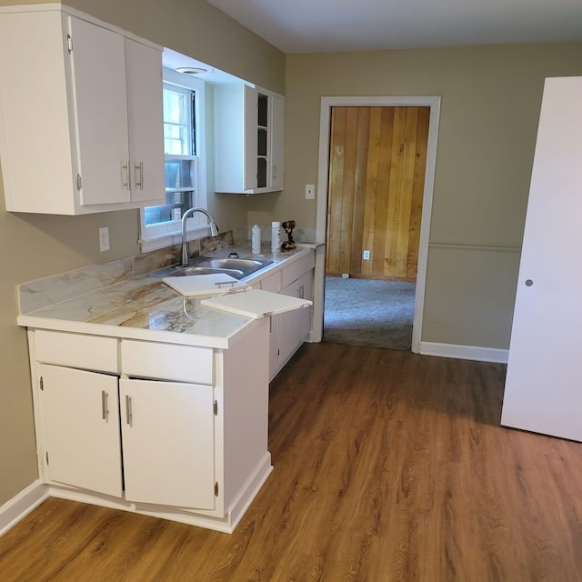 1781 Woodburn Dr, Memphis, TN 38127 - kitchen with a sink, light countertops, wood finished floors, and white cabinetry