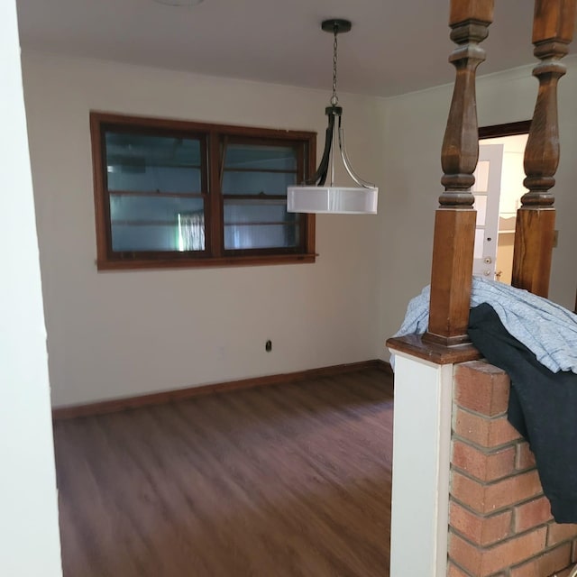 unfurnished living room featuring dark hardwood / wood-style flooring