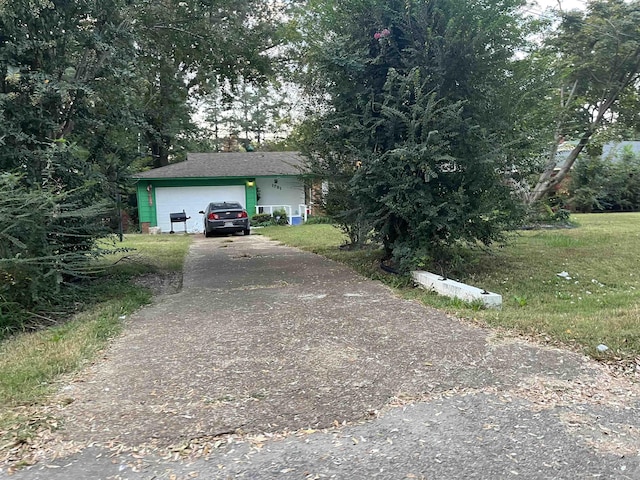 1781 Woodburn Dr, Memphis, TN 38127 - view of front of home featuring concrete driveway, a garage, and a front yard