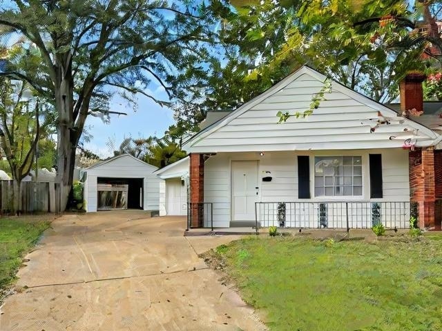 view of front of house with covered porch, an outbuilding, and a garage