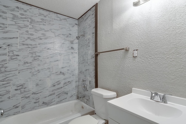 full bathroom with vanity, toilet, a textured ceiling, and tiled shower / bath combo