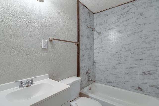 full bathroom with vanity, a textured ceiling, toilet, and tiled shower / bath combo