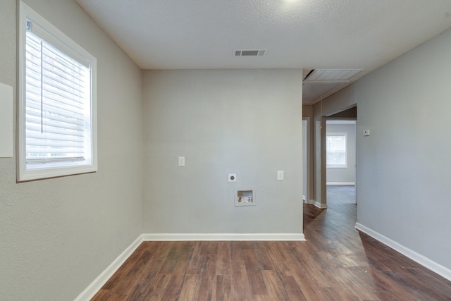 unfurnished room featuring a textured ceiling, plenty of natural light, and dark wood-type flooring