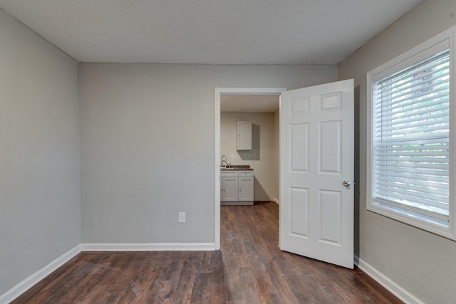 spare room with dark hardwood / wood-style flooring