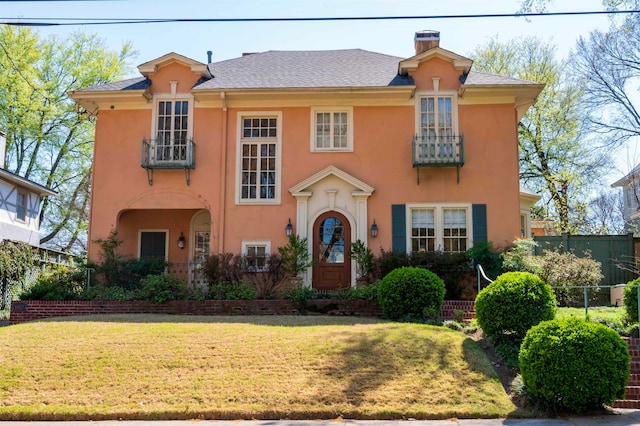 mediterranean / spanish-style home featuring a front yard