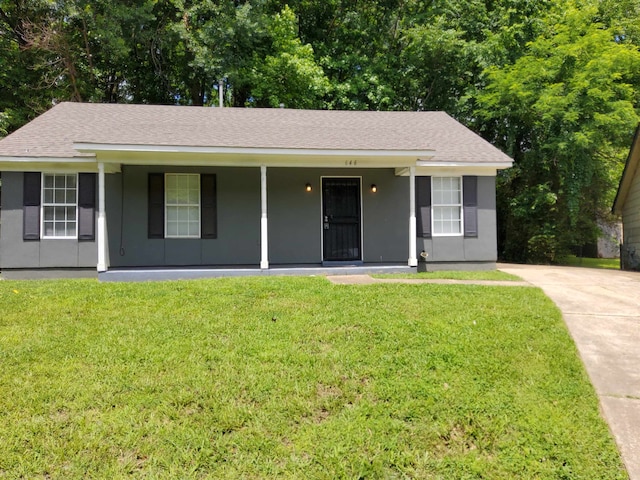 ranch-style home with covered porch and a front yard