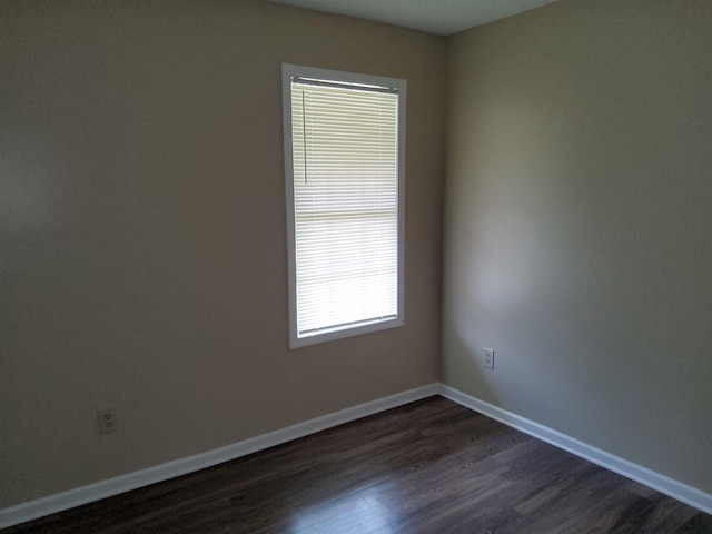 empty room with dark hardwood / wood-style floors