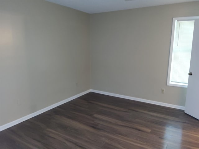 spare room featuring dark wood-type flooring