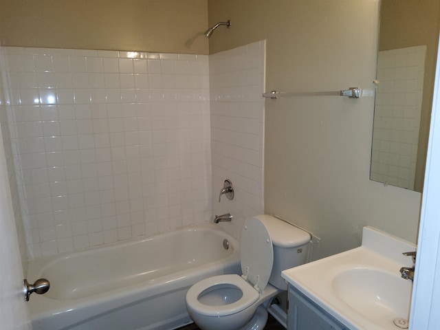 full bathroom with vanity, tiled shower / bath combo, and toilet