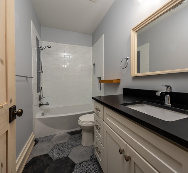 full bathroom with tile patterned flooring, vanity, toilet, and tiled shower / bath