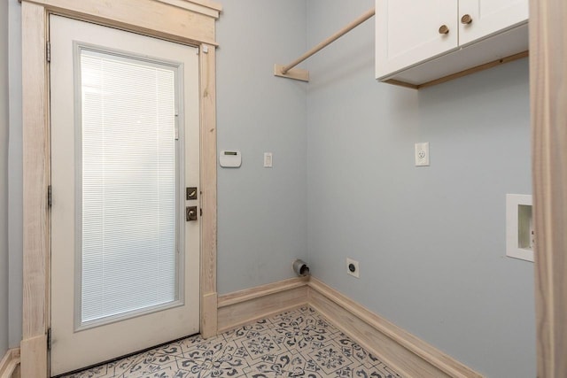 washroom with hookup for an electric dryer and cabinets