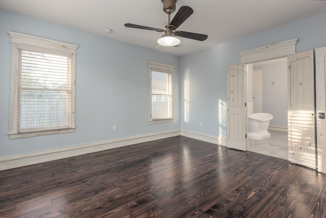 unfurnished bedroom with dark hardwood / wood-style flooring, ceiling fan, and connected bathroom