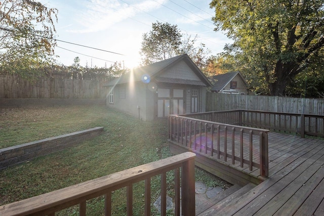 wooden terrace featuring a yard and an outdoor structure