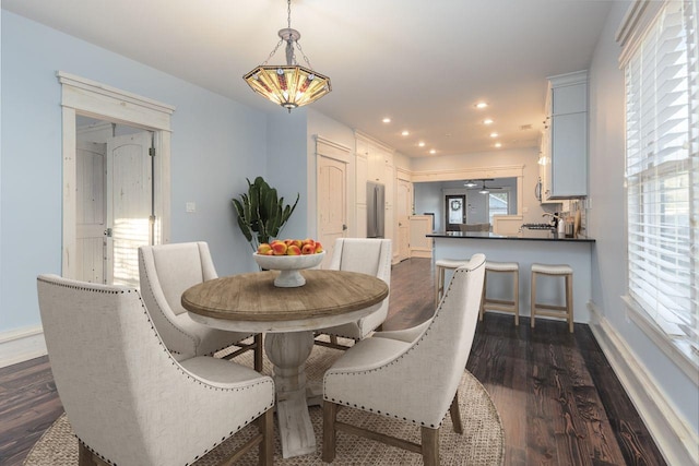 dining room with dark hardwood / wood-style floors and ceiling fan