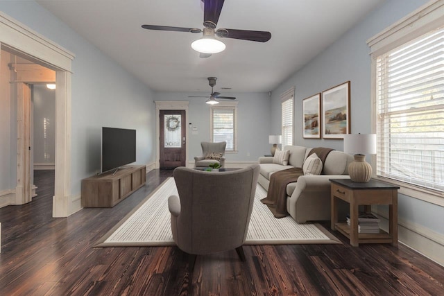 living room with ceiling fan and dark hardwood / wood-style flooring