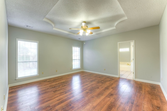 unfurnished room with dark hardwood / wood-style floors, ceiling fan, and a textured ceiling