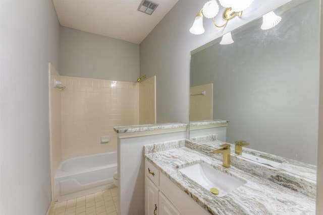 full bathroom featuring tile patterned floors, a textured ceiling, toilet, vanity, and tiled shower / bath