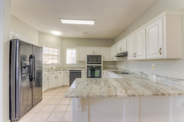 kitchen with white cabinetry, kitchen peninsula, a textured ceiling, light tile patterned floors, and black appliances