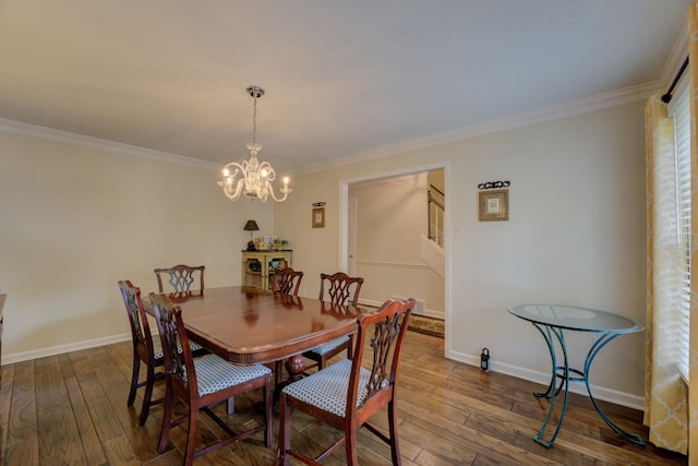 dining area featuring dark hardwood / wood-style flooring, crown molding, and a notable chandelier