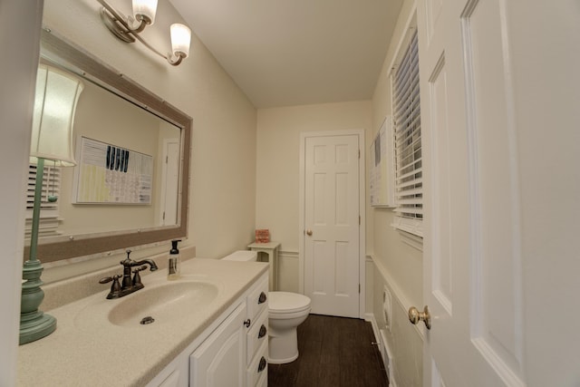 bathroom featuring hardwood / wood-style floors, vanity, and toilet