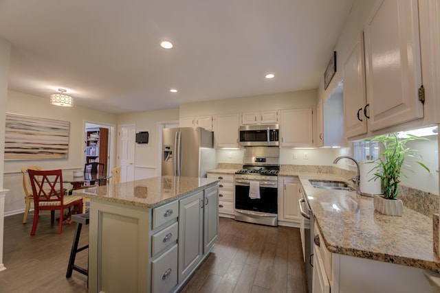 kitchen with white cabinetry, sink, a center island, and appliances with stainless steel finishes