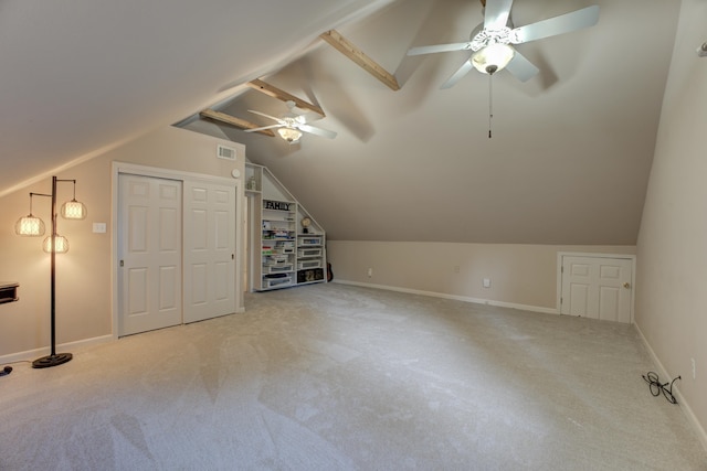 bonus room with ceiling fan, light carpet, and vaulted ceiling