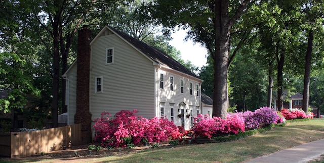 view of side of home with a lawn