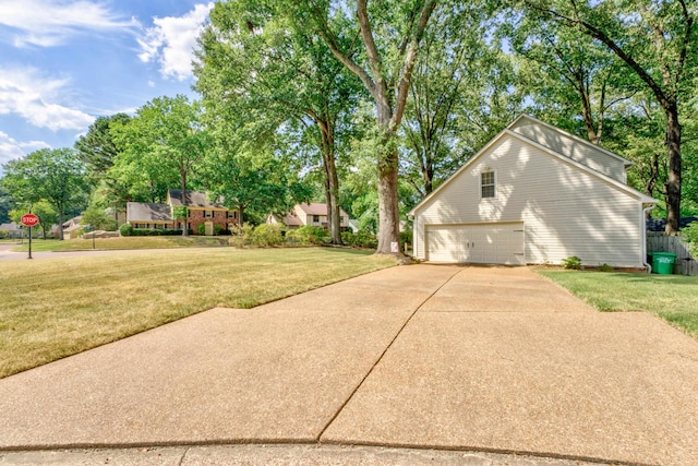 view of side of home with a garage and a yard