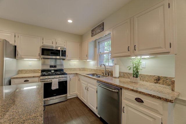 kitchen featuring sink, white cabinets, dark wood-type flooring, and appliances with stainless steel finishes