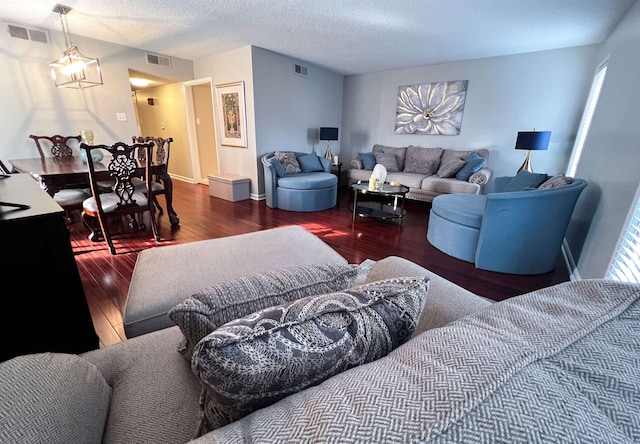 living room featuring a textured ceiling and dark hardwood / wood-style floors