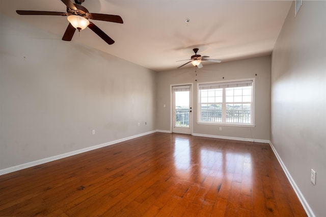 empty room with ceiling fan and dark hardwood / wood-style floors