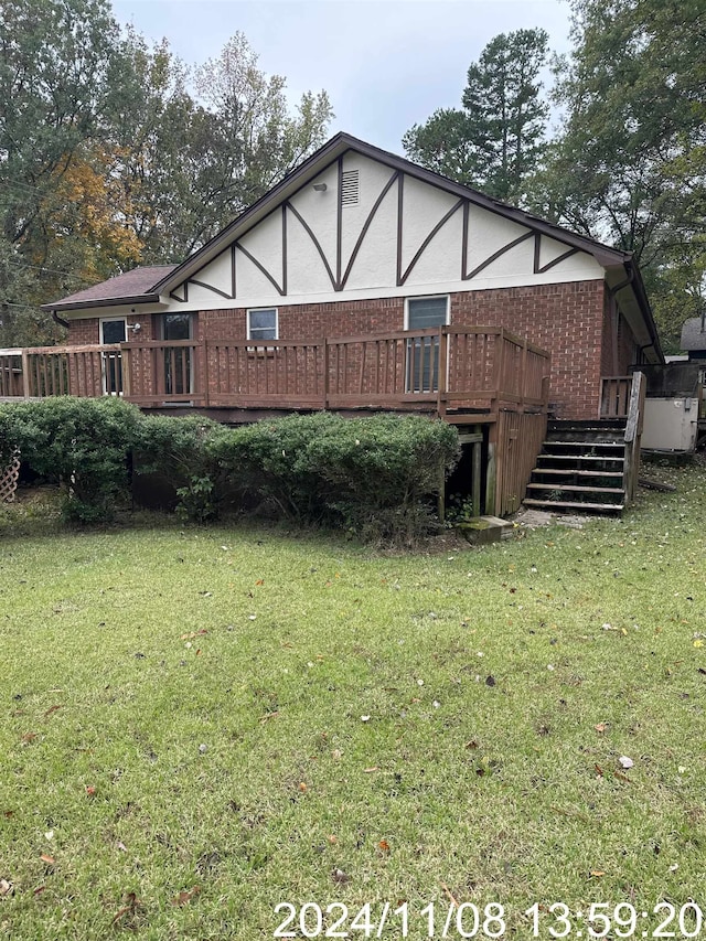 back of house featuring a yard and a wooden deck