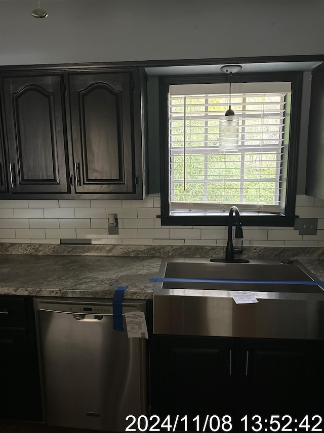 kitchen featuring decorative backsplash, a healthy amount of sunlight, sink, and stainless steel dishwasher