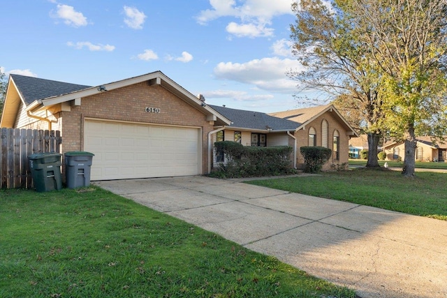 ranch-style home with a front yard and a garage