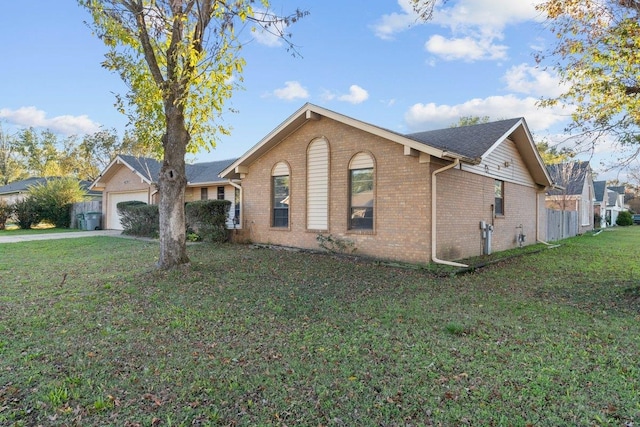 single story home featuring a garage and a front yard