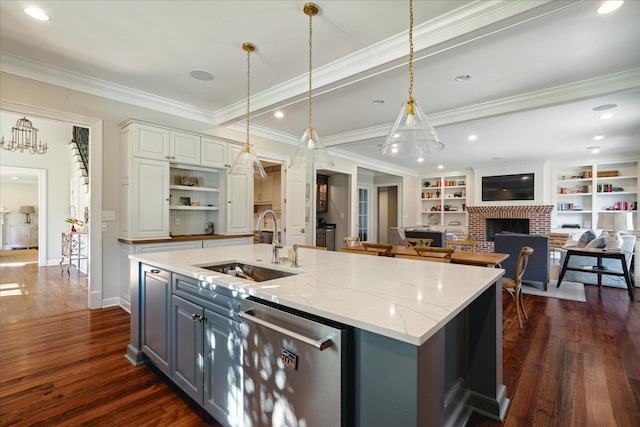 kitchen featuring white cabinetry, light stone counters, dark hardwood / wood-style flooring, stainless steel dishwasher, and a fireplace