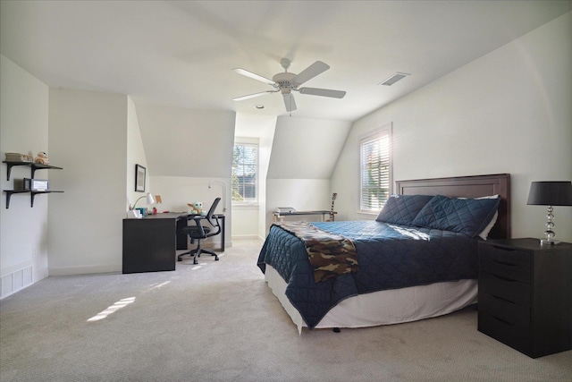 carpeted bedroom with vaulted ceiling and ceiling fan