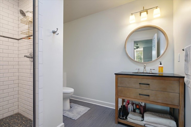 bathroom with vanity, toilet, and a shower with door