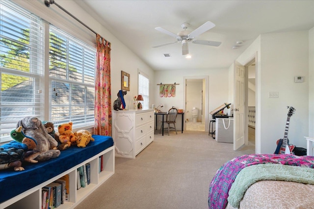 bedroom featuring ensuite bath, ceiling fan, and light colored carpet