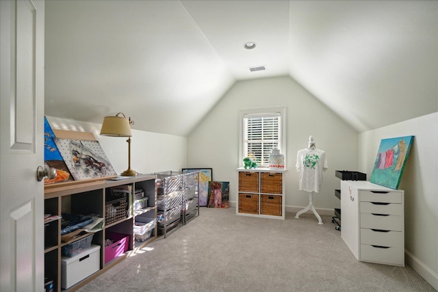 interior space with light carpet and vaulted ceiling