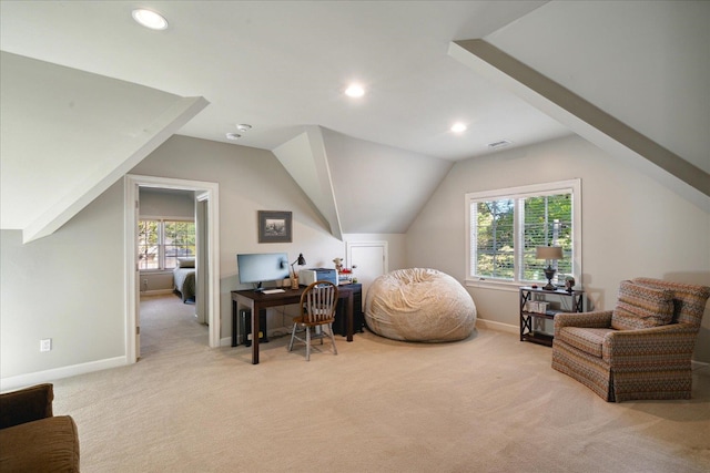 carpeted home office featuring plenty of natural light and lofted ceiling