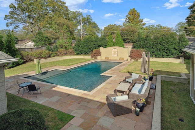 view of pool featuring a lawn and a patio area