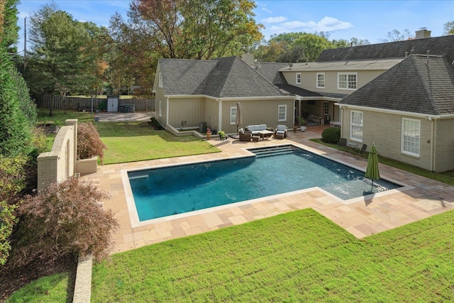 view of pool featuring an outdoor hangout area, a patio area, and a lawn