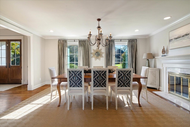 dining area featuring light wood-type flooring, plenty of natural light, and a premium fireplace