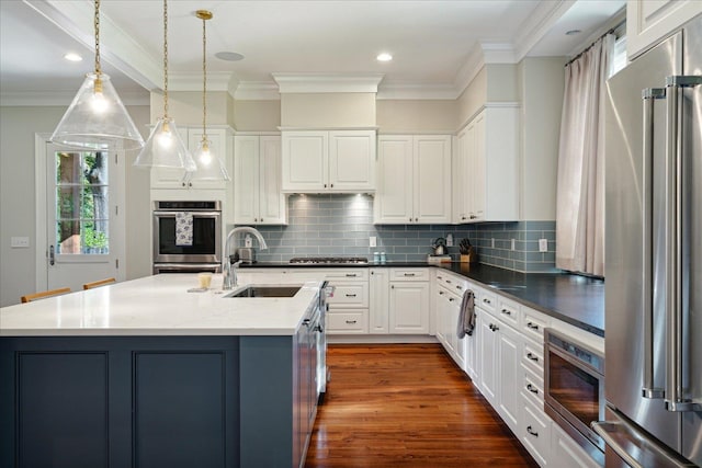 kitchen with appliances with stainless steel finishes, decorative light fixtures, crown molding, and dark wood-type flooring